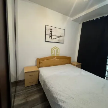 Bedroom with a double bed, bedside tables, and a wardrobe. - image 4