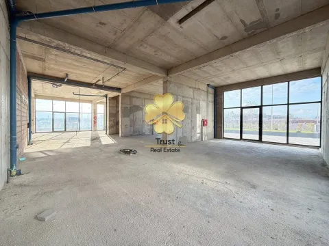 Empty commercial space in grey phase with large glass surfaces. - image 2