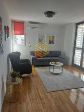 Furnished living room with a sofa and parquet flooring. - image 2