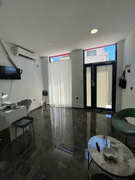 Bright living room with glossy ceramic floor tiles and modern furniture. - image 3