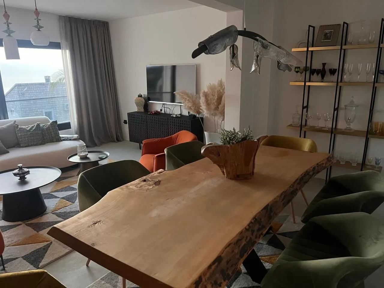 Living room with dining area and modern furniture.