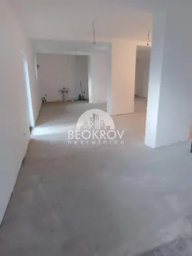 View of an empty space under construction with white walls. - image 2