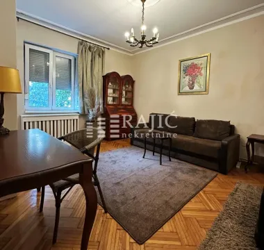 Living room with a dining table, sofa set, and hardwood flooring. - image 3