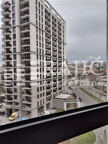 View from the terrace of a multi-story residential building and surroundings.