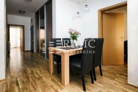 Dining area with a table and chairs inside the apartment. - image 10