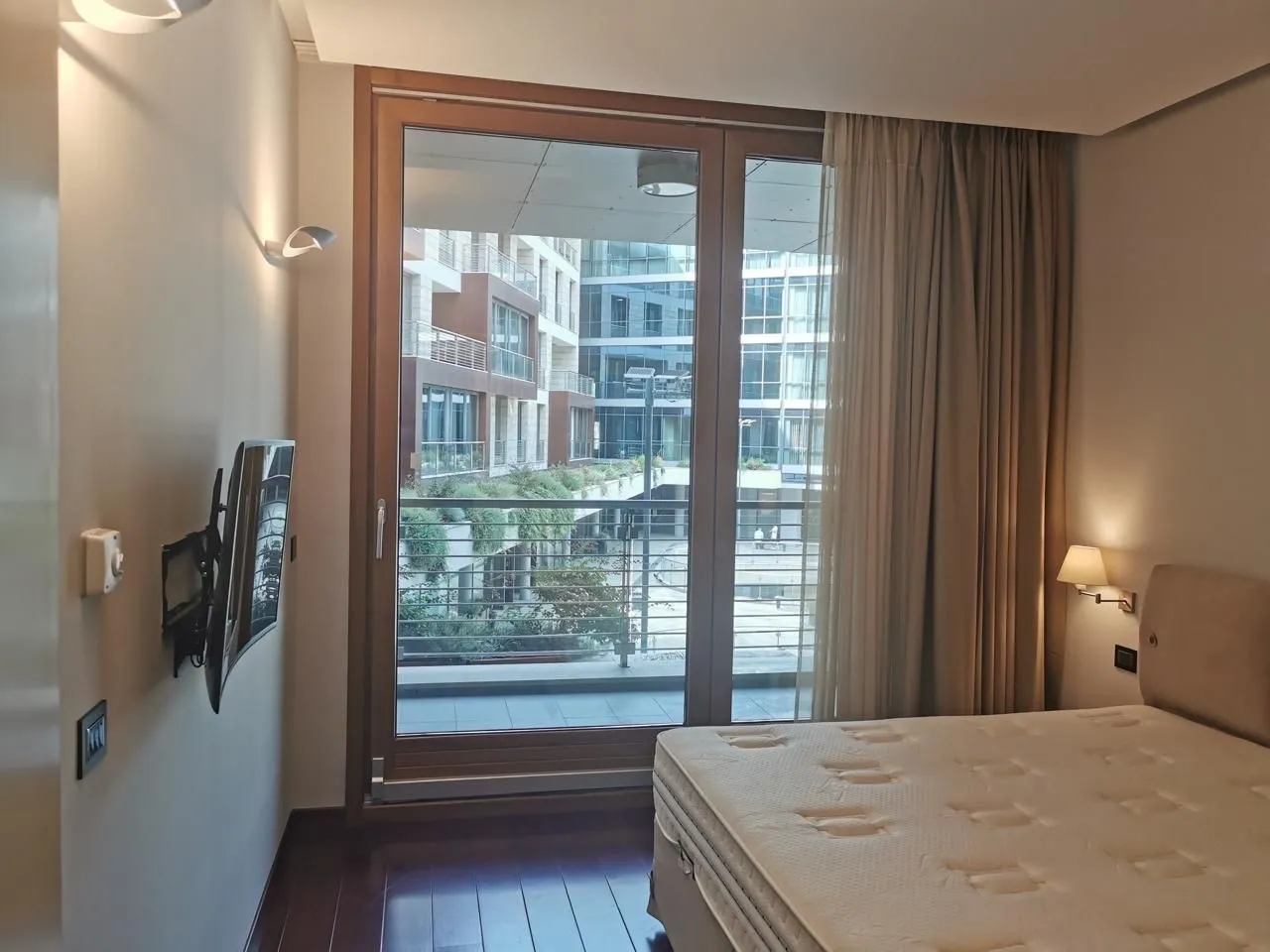 Bright bedroom with access to a terrace and courtyard view.