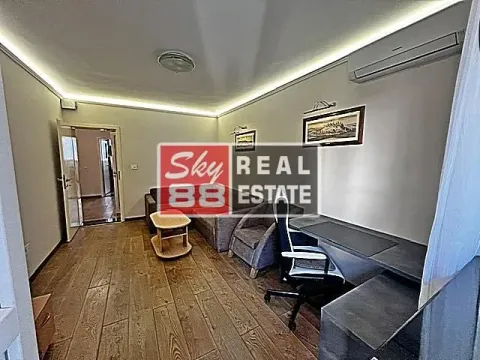Living room with sofa set, desk, and air conditioning. - image 6