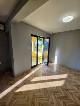 Empty room with wooden parquet flooring and access to a terrace. - image 3