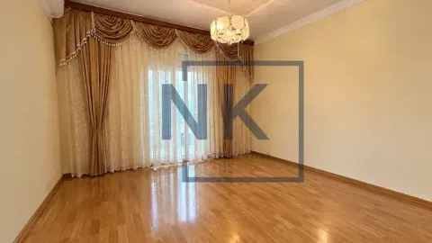 Empty living room with hardwood floors, large window, and decorative curtains. - image 3