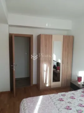 Furnished bedroom with a large wooden wardrobe and a bed. - image 7