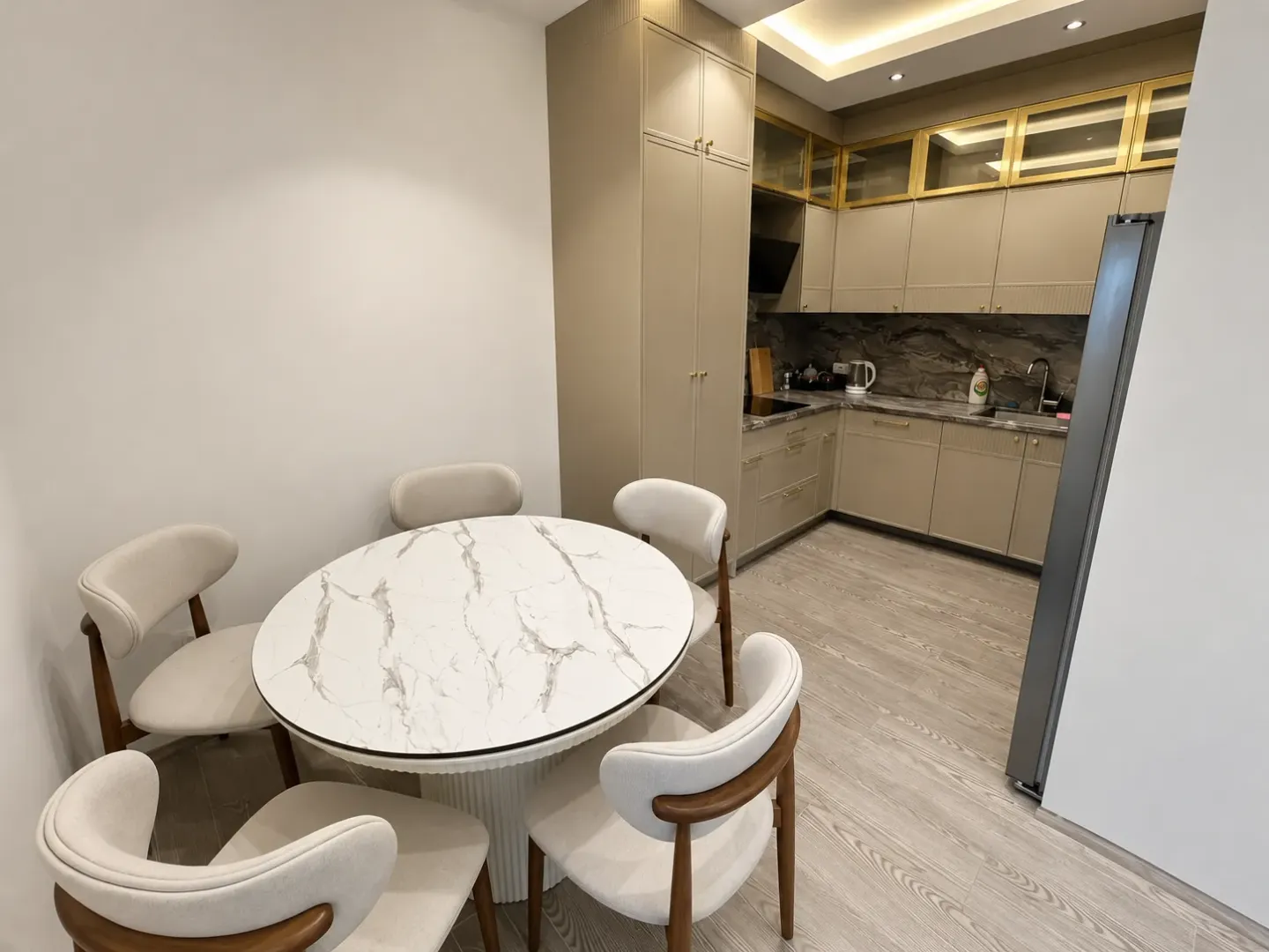 Modern kitchen with a dining table and chairs.