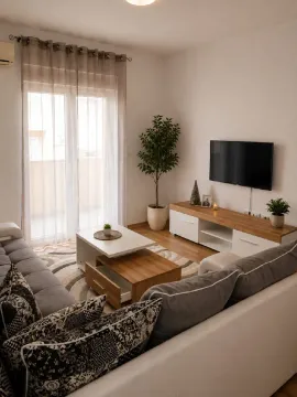 Dnevna soba sa garniturom, TV komodom i izlazom na terasu. - image 2