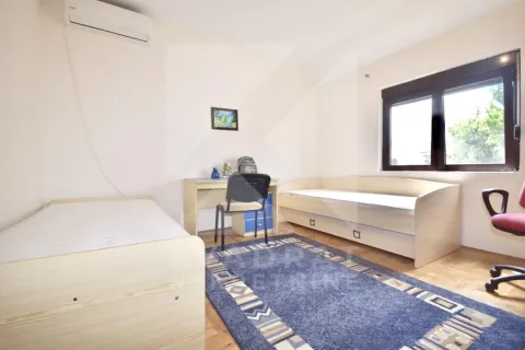 Children's bedroom with two beds, a desk, and an air conditioning unit. - image 9