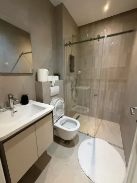 Modern bathroom with a walk-in shower and a vanity unit. - image 5