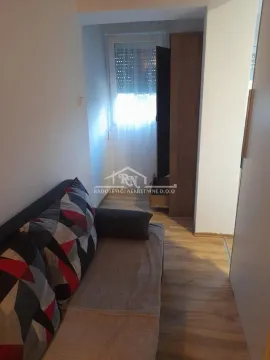 Smaller living room with a sofa and a wardrobe near the window. - image 8
