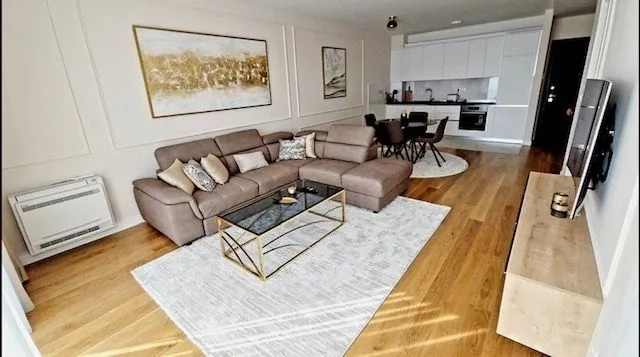 Living room connected to the dining area and kitchen in a modern apartment.