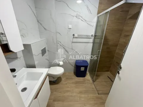 Modern bathroom with a walk-in shower, washbasin, and toilet. - image 8