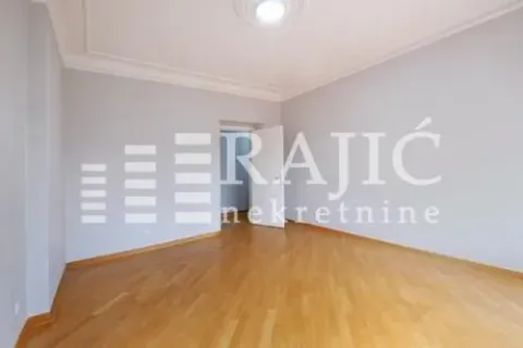 Empty room with wooden flooring and white walls. - image 4
