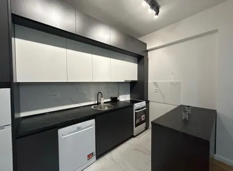 Modern kitchen with black and white cabinets and a breakfast bar. - image 3