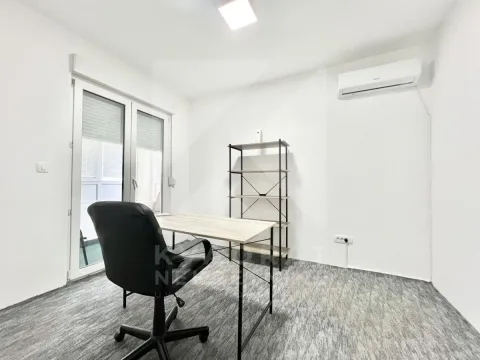 A study room with a desk, office chair, and shelving unit. - image 3
