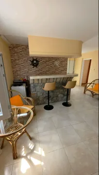 Living room with a bar counter and seating furniture. - image 8