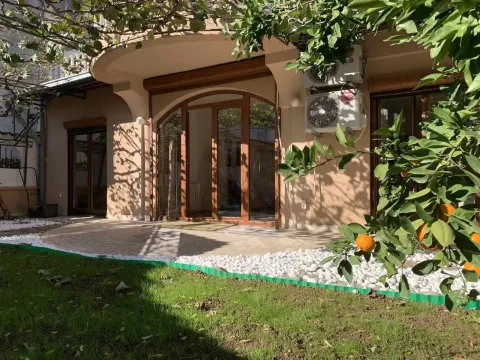Exterior of a house with a paved patio and a grassy yard with mandarin trees. - image 14