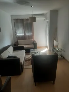 Living room with a seating set, a coffee table, and a TV. - image 2