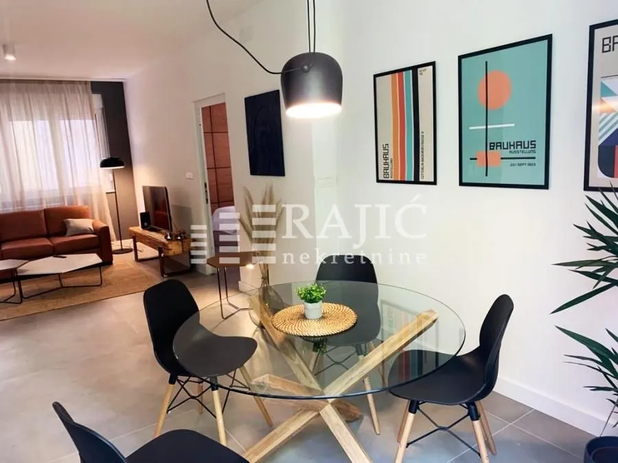 Modern living room with dining area and built-in furniture.