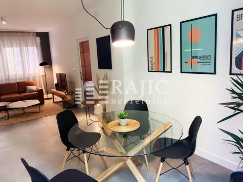 Modern living room with dining area and built-in furniture. - image 4