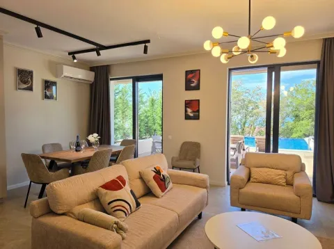 Spacious living room with a sofa set, dining area, and access to the terrace with a swimming pool. - image 22