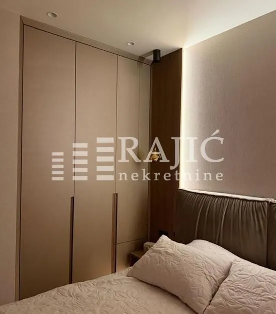 Modern bedroom with a built-in wardrobe and a double bed.