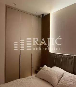 Modern bedroom with a built-in wardrobe and a double bed. - image 12