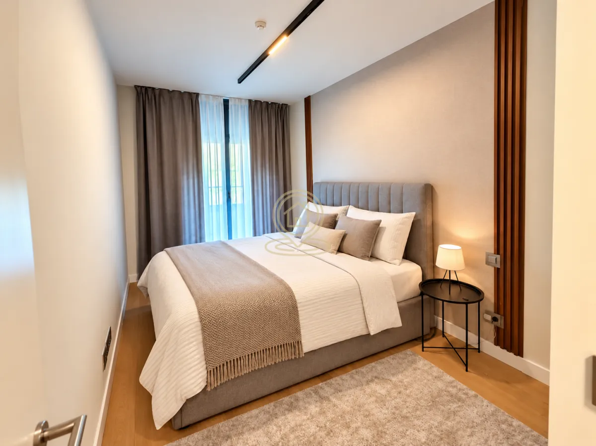 Modern bedroom with a double bed, nightstand, and curtains.
