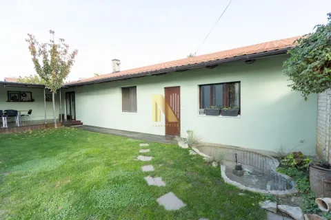 View of the courtyard and the rear side of a single-story house with a landscaped lawn. - image 5