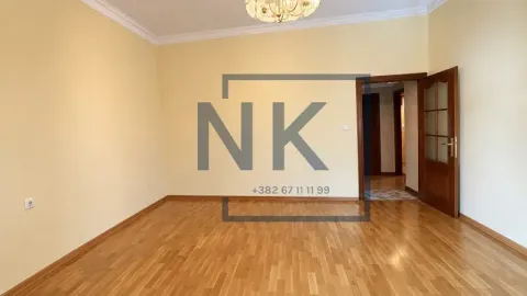 Empty room with wooden flooring and yellow walls. - image 2