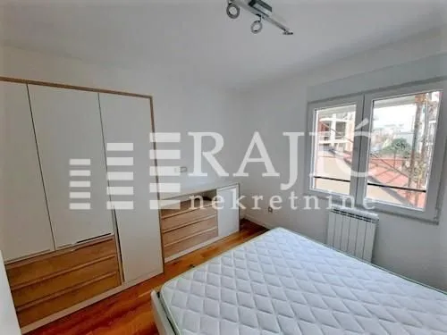 Furnished bedroom with a large double bed and a built-in wardrobe.