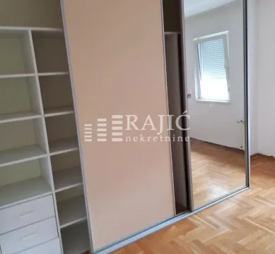 Bedroom with a built-in wardrobe and wooden flooring. - image 2