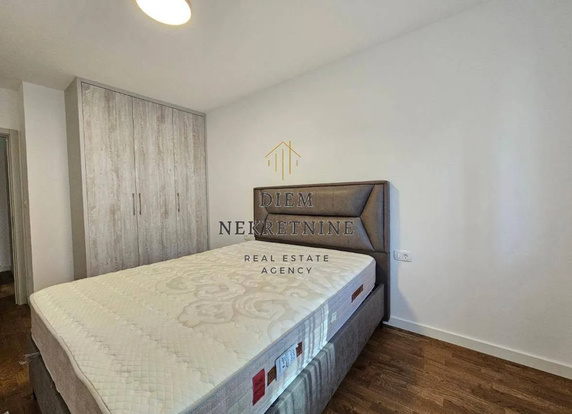 Furnished bedroom with a double bed and built-in wardrobe.
