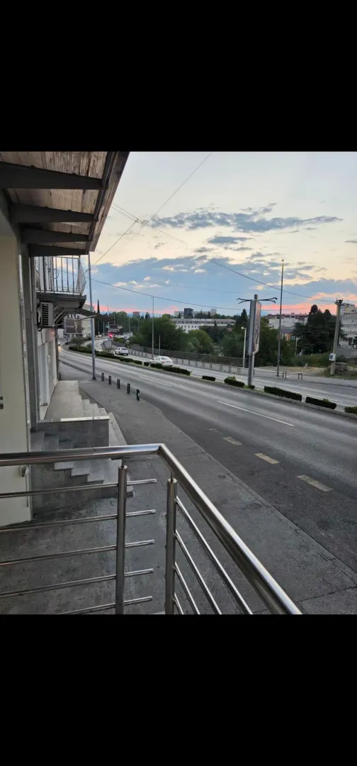 View from the terrace overlooking the city street and surrounding buildings.