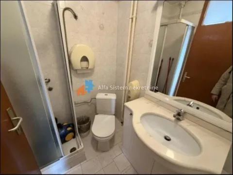 Smaller bathroom with a shower cabin, washbasin, and toilet. - image 20