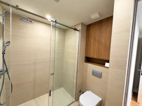 Modernly equipped bathroom with a shower cabin and built-in units. - image 4