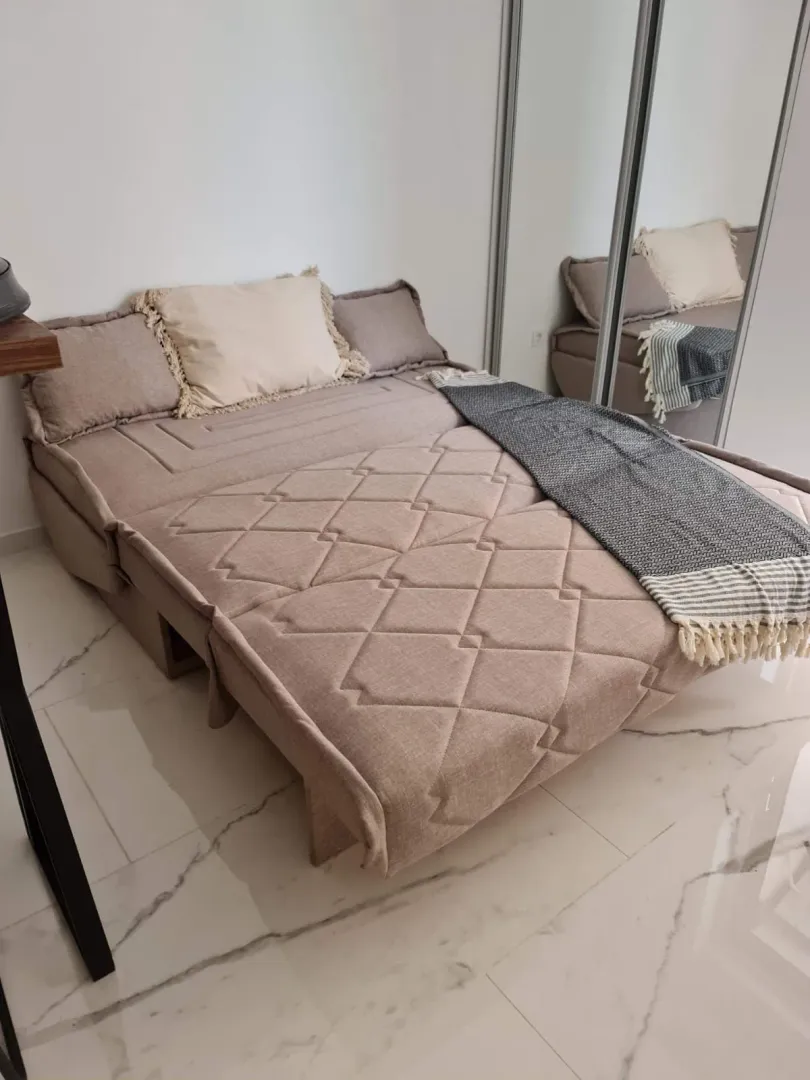 Furnished bedroom with a double bed and built-in wardrobe.