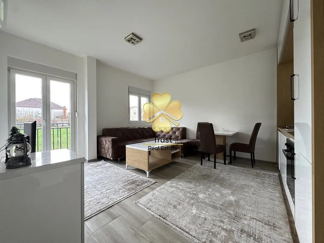 Living room with a sofa set and dining area.