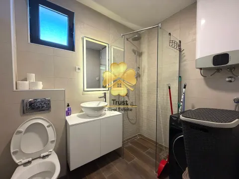 Modernly equipped bathroom with a walk-in shower and sink. - image 9
