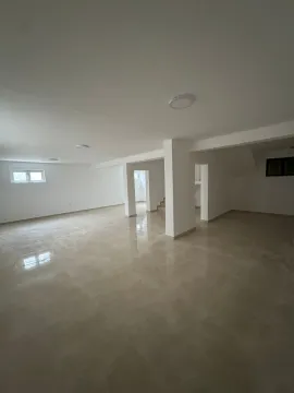 A spacious and bright empty room with light tiled flooring. - image 14