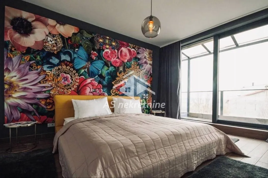 Modern bedroom with a double bed and decorative wall wallpaper.