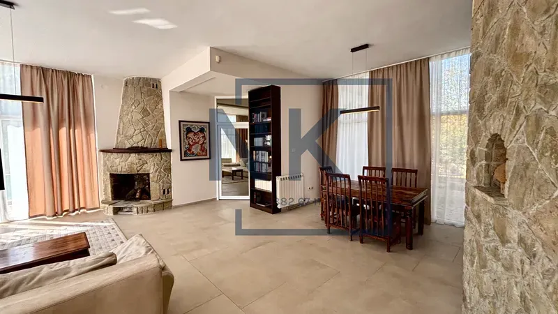 Spacious living room with a fireplace and dining area.
