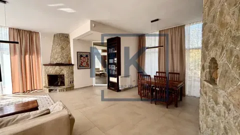 Spacious living room with a fireplace and dining area. - image 6
