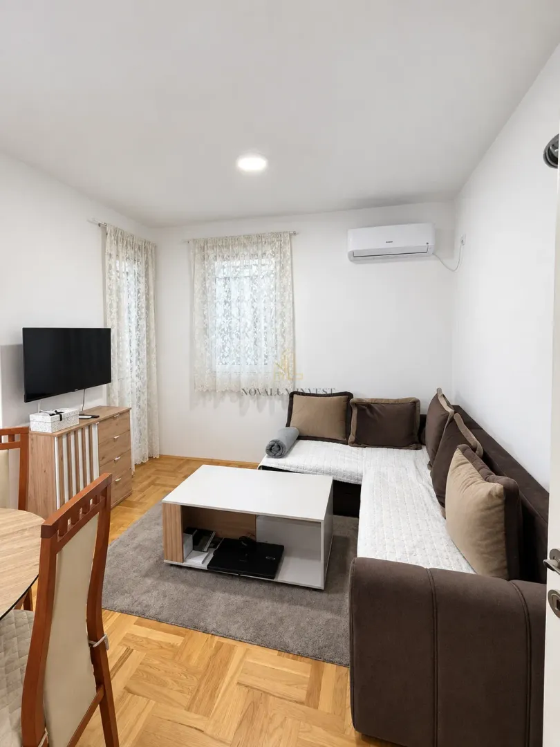 Living room with a sectional sofa, coffee table, and TV.