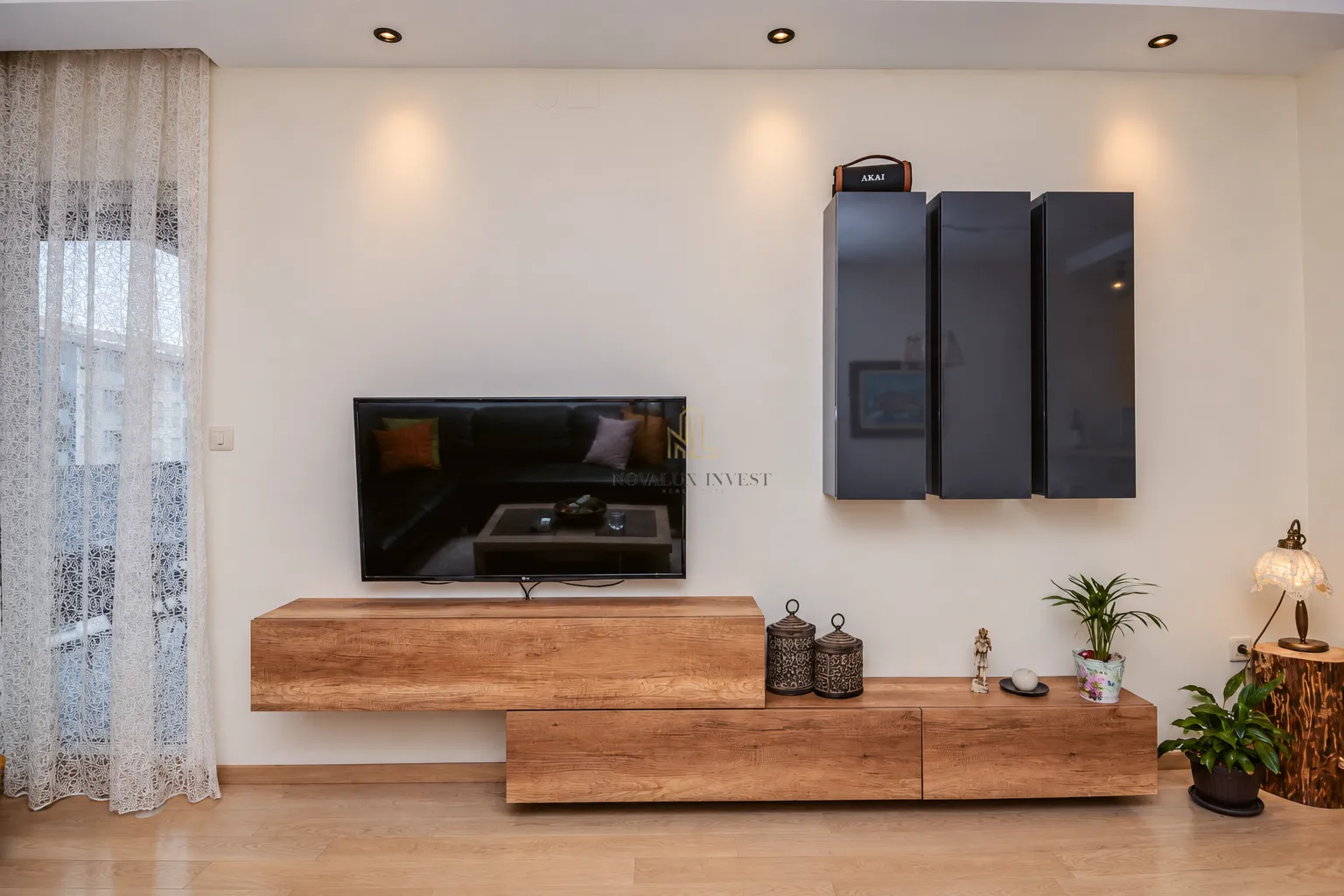 Living room with a TV unit and hanging cabinets.